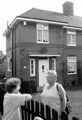 Neighbours chatting outside their homes at 362 and 364 Southey Green Road