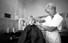 Hairdresser Lisa Carter with a young customer at JJ's Hair Stylists, Buchanan Road