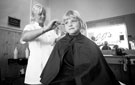 Hairdresser Lisa Carter with a young customer at JJ's Hair Stylists, Buchanan Road