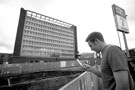 Student taking a mobile photograph of the archaeological dig outside Sheffield Midland railway station showing (back) Sheaf House, Sheaf Square