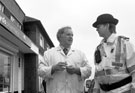 Police Community Support Superintendent talking to butcher Erich Suck by Margetson Crescent shops