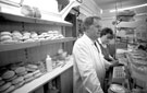 Shop assistant Caroline and Erich Suck in Erich's butcher/grocery shop, Margetson Crescent