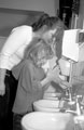 Nursery Nurse Maria Parker helping children wash their hands at Denby Street Nursery, Highfield