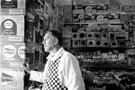 John Scott with his walls of crisps at his general store on Lindsay Avenue