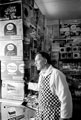 John Scott with his walls of crisps at his general store on Lindsay Avenue