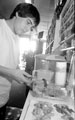 Shop Assistant, Dominic Podmore feeding a corn snake, The Snake Shop, No. 678, Attercliffe Road