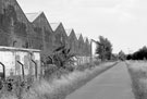 Transpennine Trail alongside Blackburn Road showing rear of Yorkshire Engine Co