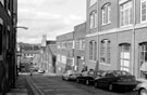 Walsh Court (extreme right) originally the premises of John Walsh Ltd., Cabinet Works, furniture depository and factory; Bells Court Garage; Nos. 28-42, Paramo Tool Group, hand tool manufacturers, Bailey Street looking  St. Vincent's R.C. Church