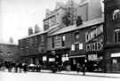 View: s00244 Fargate now Barker's Pool, including (left-right), No. 94 E. Renwick, basket maker, Nos. 90 - 92 Charles Constantine Ltd., ironmonger, No. 88 opticians, No. 86 Campion Cycle Co. Ltd., cycle agents