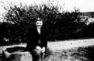 Jim Andrews resting on the horse trough at Sally Clarke's Cottage, Woodhouse