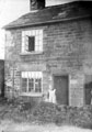 Mrs. Elliott at the door of a cottage on Gleadless Road