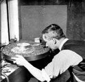 E. Speight soldering the foot onto a silver dish, Atkin Brothers, silversmiths, Truro Works, Matilda Street