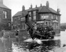 Flooding at Beighton. Horse and cart carrying men from the pits, Crown Terrace, Rotherham Road, Railway Inn in background