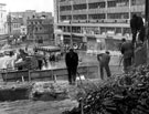 View: s13006 Arundel Gate and Castle Square, construction of subway and roundabout, workmen are reducing the size of J. Walsh and Co., department store to allow for road widening