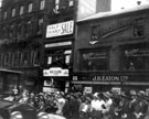 View: s15551 Unidentified royal visit passing Fargate, possibly Elizabeth, Queen Mother, 1934, shops include Nos. 41 - 43 J.B. Eaton Ltd., drapers and Marsh Brothers (Electricians) Ltd., No. 37 H.E. Closs and Co. Ltd., silk merchants, No. 35 Yates and Henderson