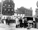 View: s16073 Newspaper vendor, Fitzalan Square, Bell Hotel, No. 9 The Sleep Shop, bedding retailers, No. 11 Henry Wigfall and Son Ltd., house furnishers in background