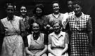 Mrs. Williamson 3rd from left next to her sister, 4th from left in the company of ladies in the back yard, Darnall