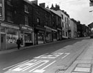 View: s17471 Howard Street, premises include No. 82, Mrs. E. Moore, hairdressers, No. 80 Abbey Glen Laundry Co., No. 78, Edward Willis Ltd., butchers, No. 76 Harold Brook (News) Ltd., No. 72 Arthur Davy and Sons, provision dealers and No.70 County Hotel