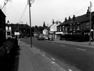 View: s17743 Main Road, Darnall near the junction of Beighton Street (first left) showing No. 271/273, Bennettts of Sheffield Ltd., fishing tackle dealer and No. 281, Doreen Crookes, hairdressers and looking towards Holy Trinity Church in the background