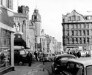 View: s18359 Norfolk Street looking towards junction with Tudor Way, Wilks Brothers and Co. Ltd., right, St. Marie's Church and Victoria Hall, left