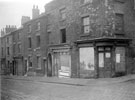 View: s19582 Derelict back to back housing and shops, South Street at junction of Gilbert Street, entrance to Court No 9, under arched passage