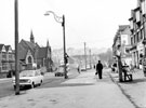 Stubbin Lane looking towards the roundabout and Firth Park Road showing Firth Park United Methodist Church and various shops including No. 3 H. E. Purcells, fancy goods