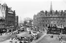 Elevated view of Town Hall Square and Fargate, including No. 66, Fleur de Lys public house, (Bovril sign) and Bank Chambers, left. Albany Hotel and Yorkshire Penny Bank, right. Town Hall Square Rockery in foreground