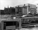 View: s23021 Construction of a subway under Arundel Gate with the rear of the Taxation Office on Eyre Street; Leader House and Cenral Library in the background