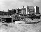 View: s23022 Construction of a subway under Arundel Gate with the rear of the Taxation Office on Eyre Street; Leader House and Cenral Library in the background