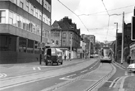 View: s24000 Supertram No. 9 travelling along Glossop Road to Herdings Park showing (left) No. 231 Spring House, offices, No.243 National Westminster Bank and the junctions with Victoria Street (extreme left and right)