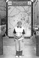 View: s24760 Advertising stand on Surrey Street with World Student Games volunteer, Beatrice Padley standing in front of it