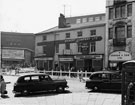 View: s25926 The Elephant Inn, Nos. 2 - 4, Norfolk Street and Nos. 18, G. E. Inman Ltd; 14 - 16, John Smiths Tadcaster Brewery Co. Ltd. office, 12, F. Corker and Son Ltd., fruitiers and The White  Building, Fitzalan Square and  Odeon Cinema