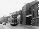 Tram No. 289 travelling past No. 108, Manchester Hotel and John Aizelwood Ltd., flour miller, Crown Flour Mill, Nursery Street with Bridgehouses Goods Station in the background (1955-1960)