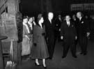 View: s28356 After watching the tapping of a furnace and talking to two workmen, Queen Elizabeth II accompanied by Mr. Herbert Renshaw and J.W. Foster at the English Steel Corporation, River Don Works, Brightside Lane during the royal visit   