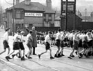 Boys from Wadsley Bridge Council School crossing Penistone Road North with the Gate Inn and the sign for the Travellers Inn in the background