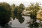 Looking upstream from East Coast Road showing the Five Weirs Walk footpath and fishing platform near the site of the Crown Works