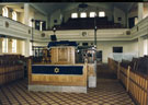 Interior of Wilson Road Synagogue showing the Reader's Desk and the womens gallery above