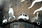 View: t03309 Car Mural Sculpture by Johnny White on the wall of Harratts Volvo Sheffield, Vulcan Foundry, Attercliffe Road