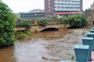 River Don in flood at Blonk Bridge, Blonk Street with Park Inn (formerly Hotel Bristol) in the background from the Five Weirs Walk