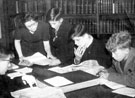 School leavers practising using books for information at unidentified  library