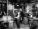 Man and Boy at work at a Beltdriven Drop Hammer