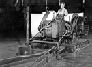 Female worker coiling strip steel at Hallamshire Steel and File Company, Neepsend Lane