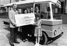 View: u06273 Ray Gridley handing over the Ticket to Sheffield and Ecclesall Co-op milkman, Alan Smith who became the first person to book for the World Student Games with wife Gillian; children Richard and Kerry