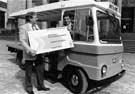 View: u06274 Ray Gridley handing over the Ticket to Sheffield and Ecclesall Co-op milkman, Alan Smith, who became the first person to book for the World Student Games pictured 