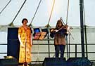 Librarian Judith Adam of Sheffield Libraries and Information Services singing at the Millennium Multicultural Festival which took place on Devonshire Green after the Lord Mayor's Parade