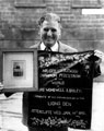 Kenneth Littlewood, with his grandfather's (George Littlewood 1859-1912) photograph and banner