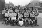 View: v01759 Football Team Photograph, Winners of the Wednesday Shield 1928/9, Teacher Mr. Fletcher (left) and Headmaster Mr. Dobson (right), Shiregreen Council School
