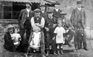 Group of men and children. All the men worked in Bell Hagg quarry