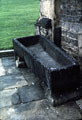 Old coffin used as a water trough outside Turret Lodge, Manor House