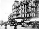 High Street, at bottom of Fargate, Foster's Buildings in background including Nos. 10 - 16 W. Foster and Son Ltd., tailors; No. 8 Kingdon and Son, tobacconist, No. 6 Boots Cash Chemist